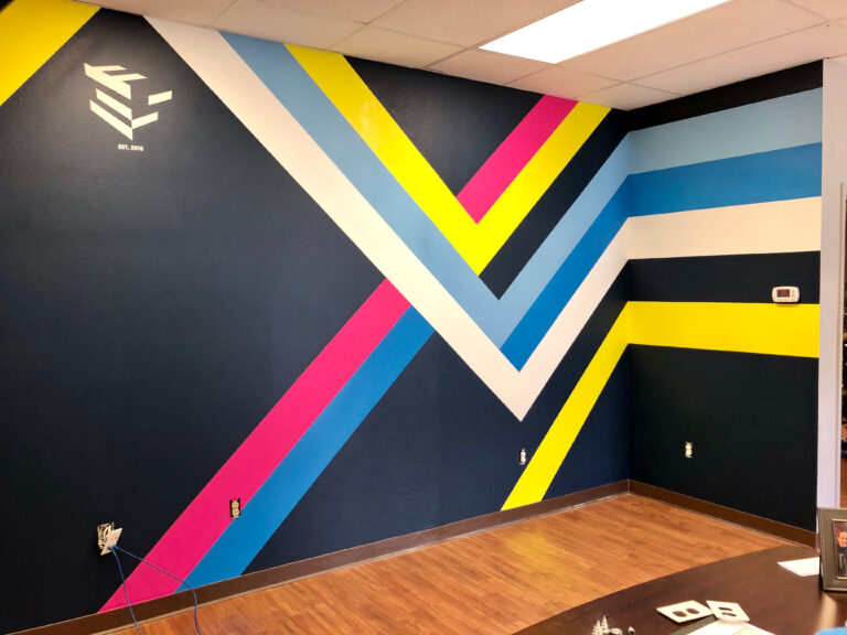 Color Bars interior office mural by A Pivotal Character Artworks & Design in Orlando, Florida, which features neon color stripes interwoven into a geometric pattern against a black background.